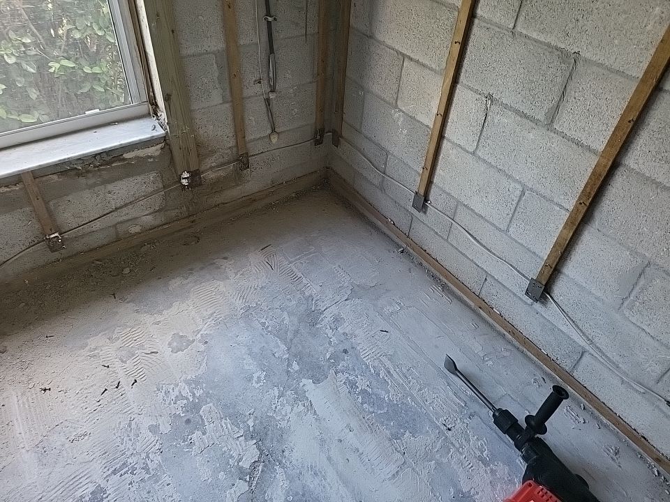 Room stripped to bare block walls and concrete floor during fire damage restoration